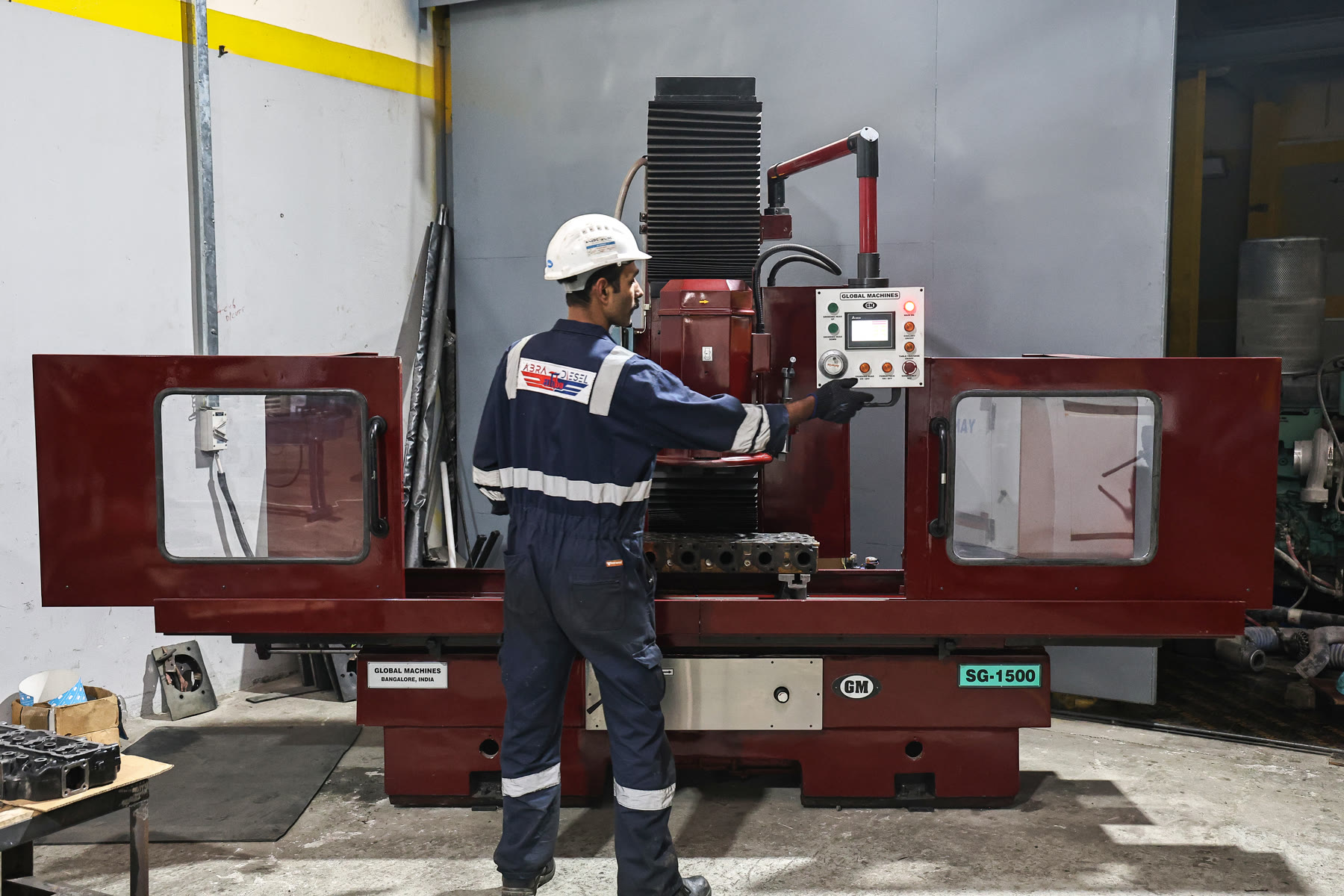 Technician operating the cylinder head surfacing machine