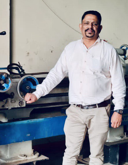 Machinist standing alongside a lathe in the Abra Diesel workshop