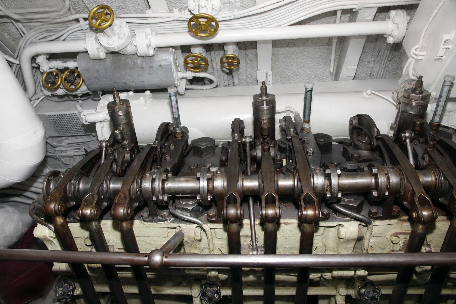 Exceptionally detailed wide view of the Lembit submarine diesel engine and dense surrounding pipework.