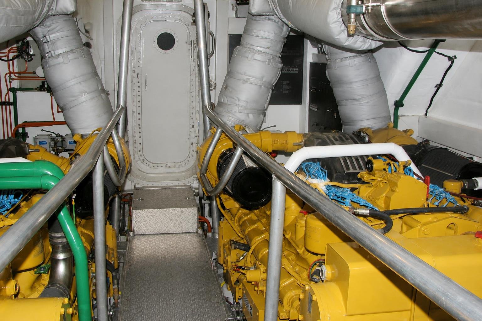 Bright operational engine room of a Severn-class rescue lifeboat with twin 1250 hp diesels.