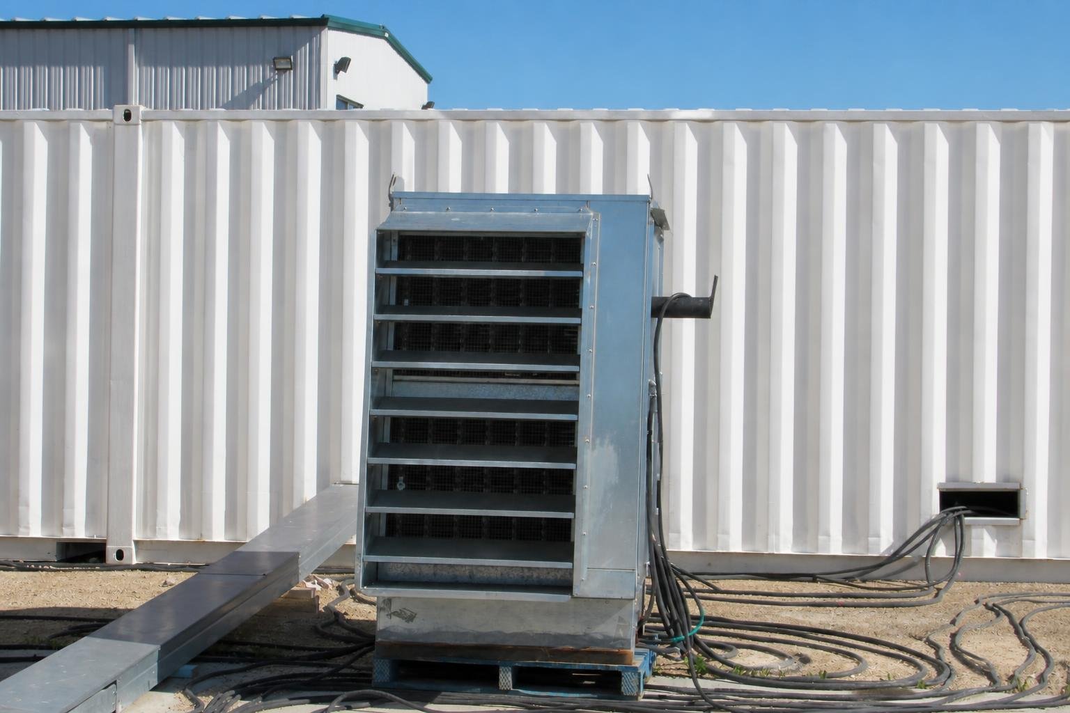 Large air-cooled load bank connected for acceptance testing and factory run-in of a 3000 kW standby genset.