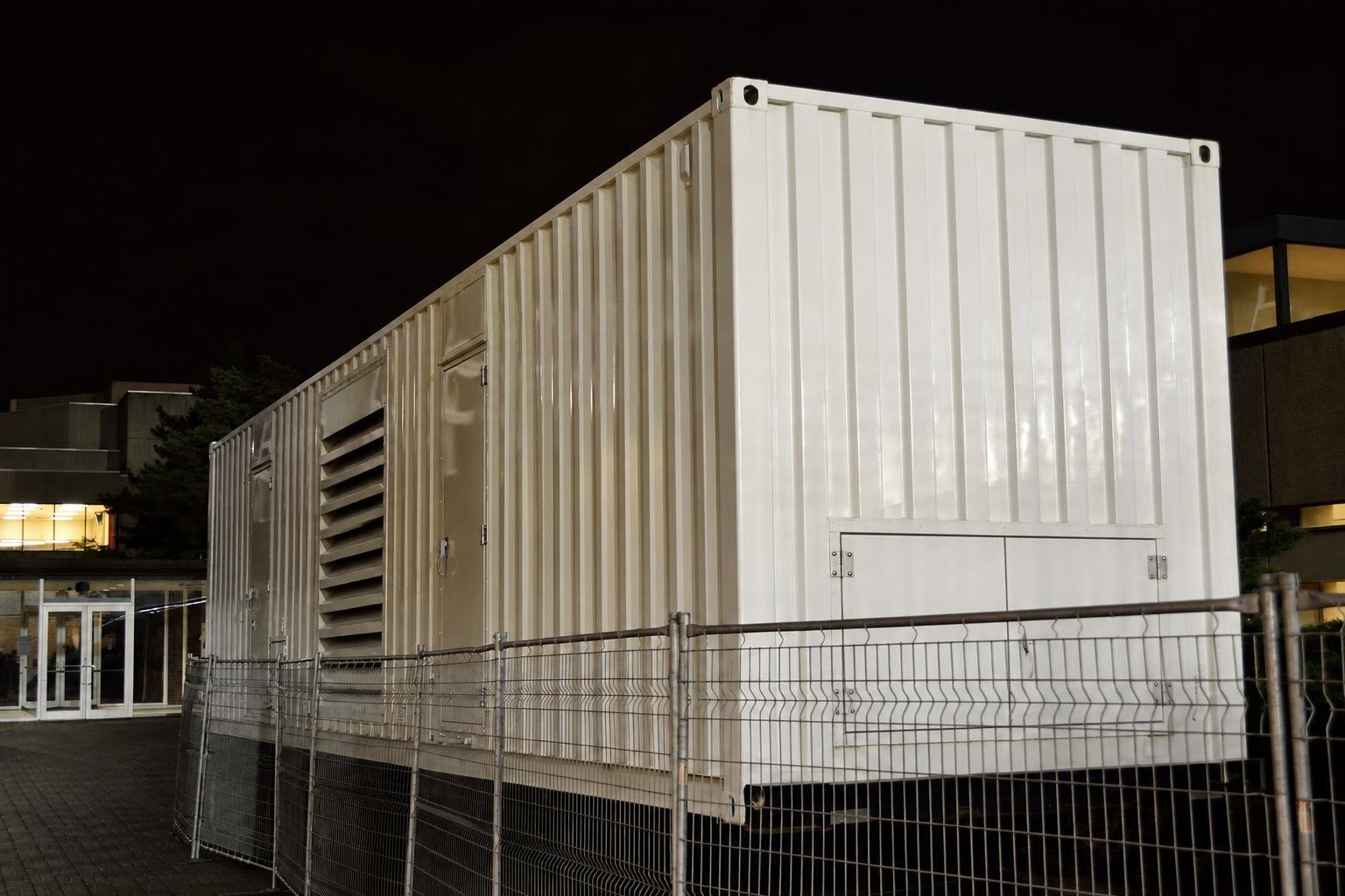 Large emergency power generator integrated into a weatherproof shipping-container enclosure.