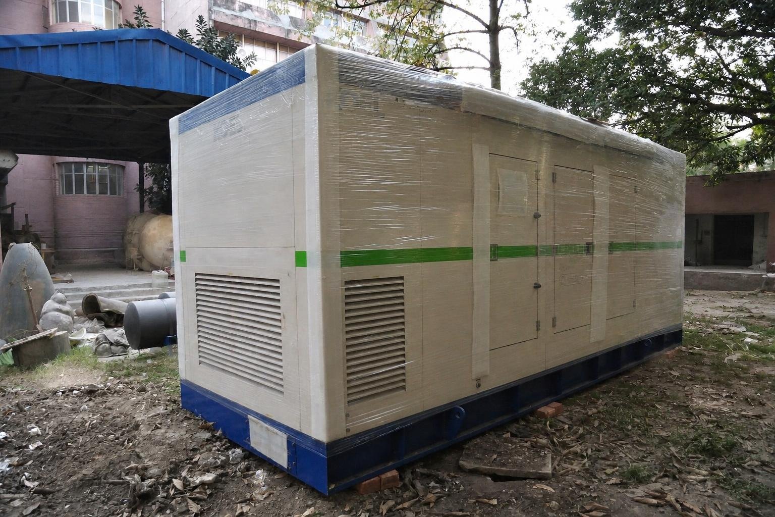 High-resolution field photograph of a medium commercial KOEL Green sound-enclosed diesel genset.