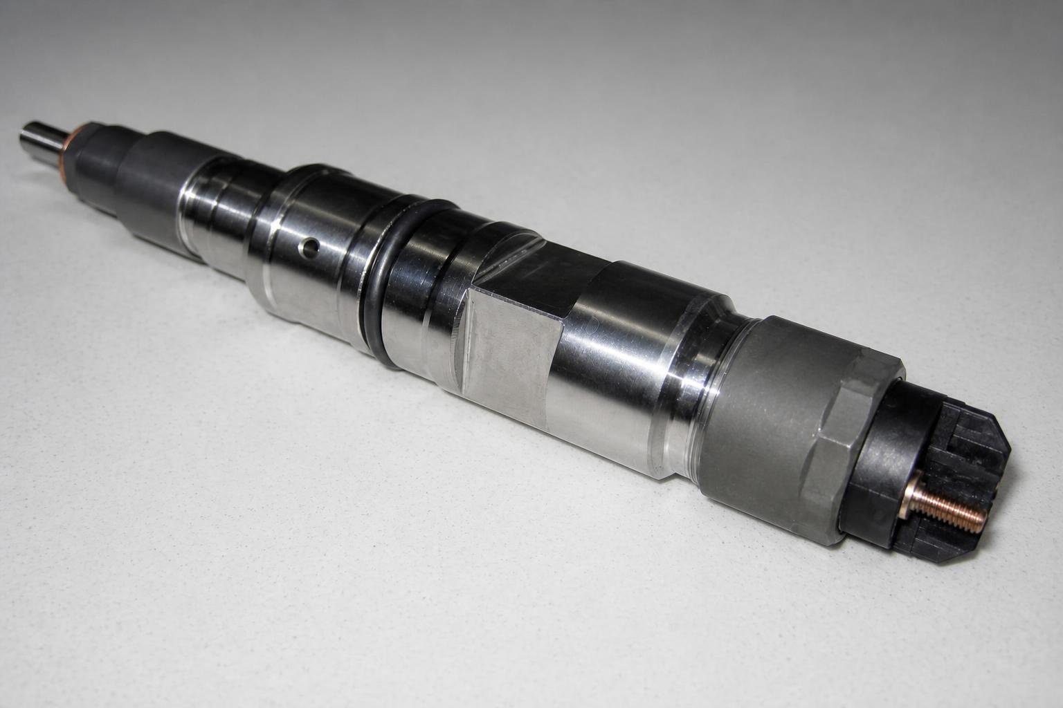 Isolated close-up of a substantial Bosch common-rail injector from a Deutz 7.2 L diesel engine.
