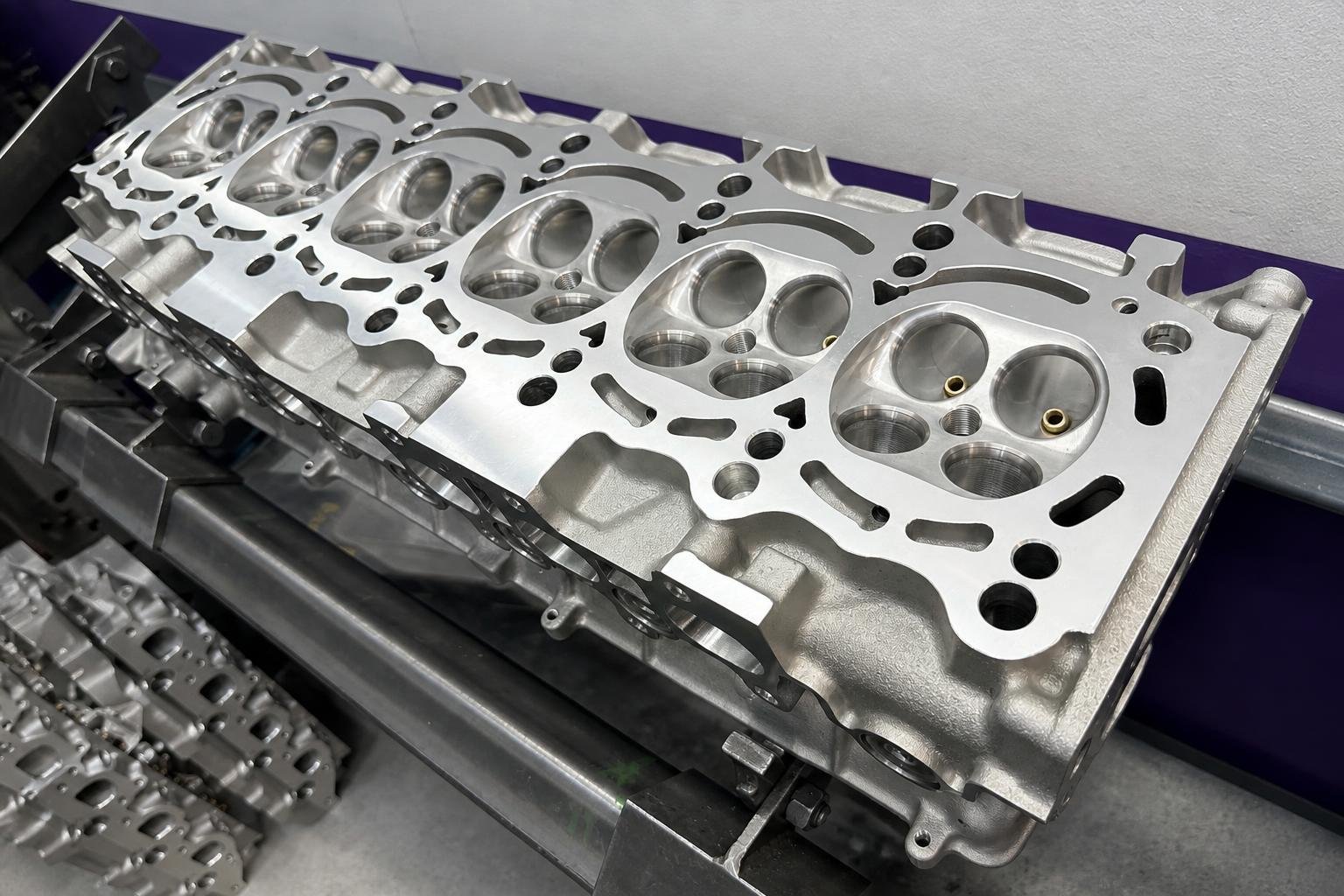 Machined cylinder-head components arranged during professional workshop assembly.