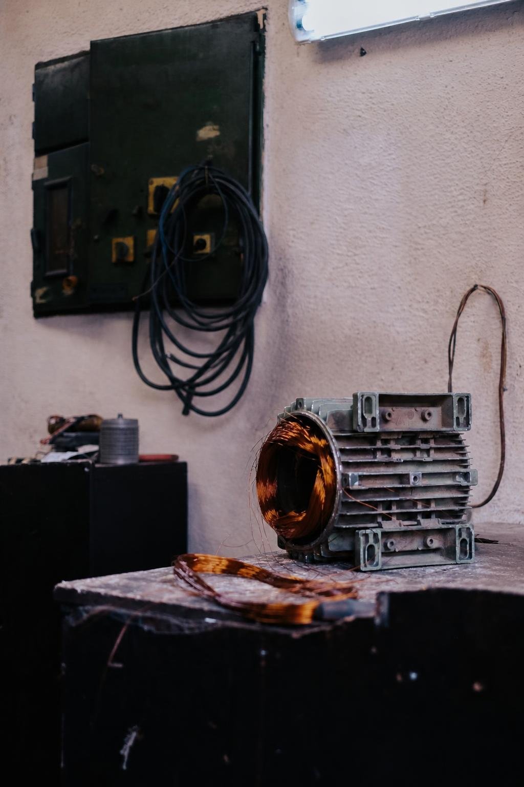 Hands-on close-up of a technician servicing and repairing a charging alternator.