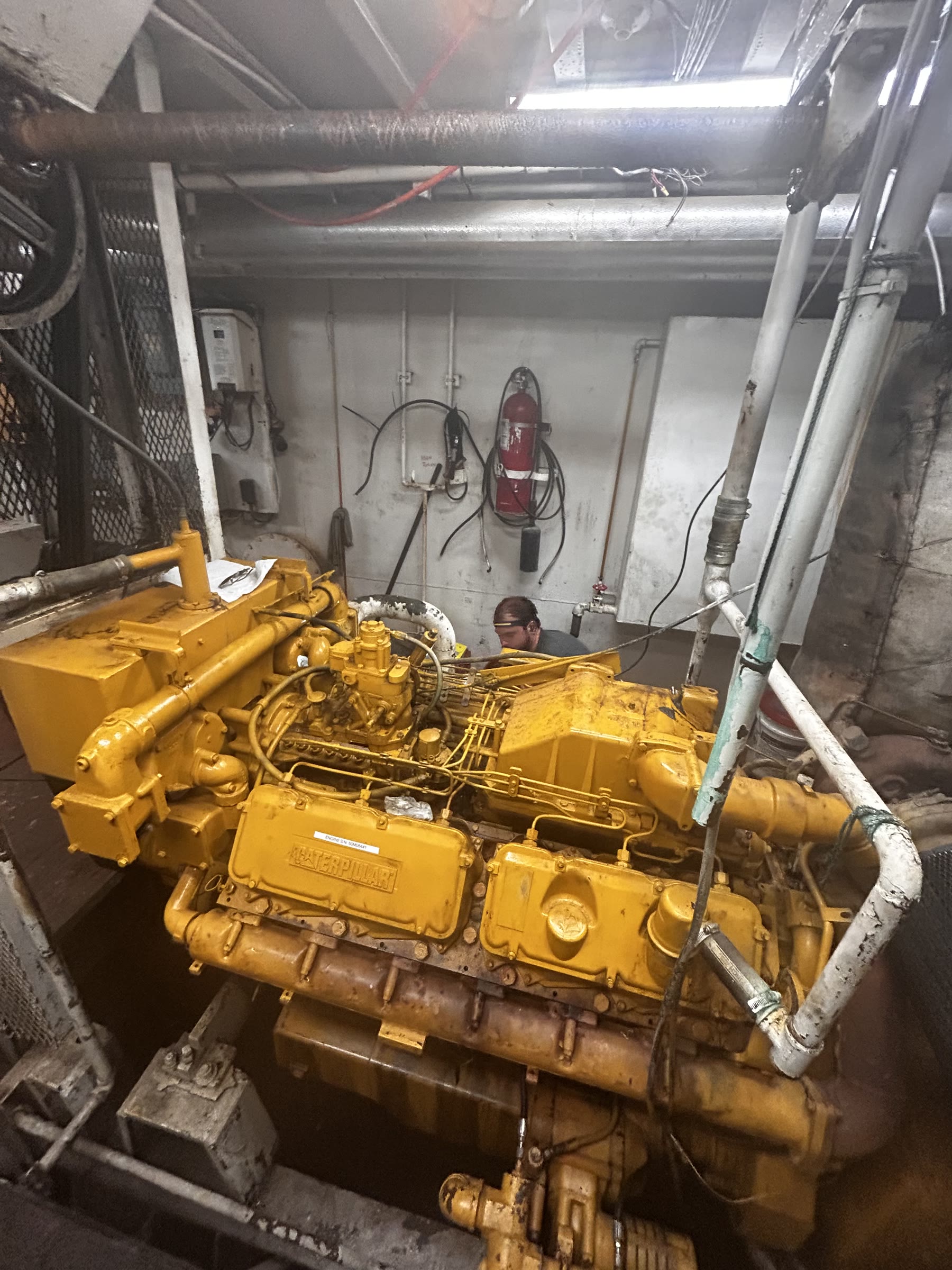 yellow CAT V-engine in a plant room / ship engine room