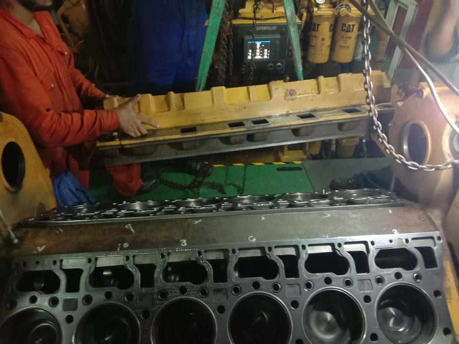 Engine block being lifted in for inspection